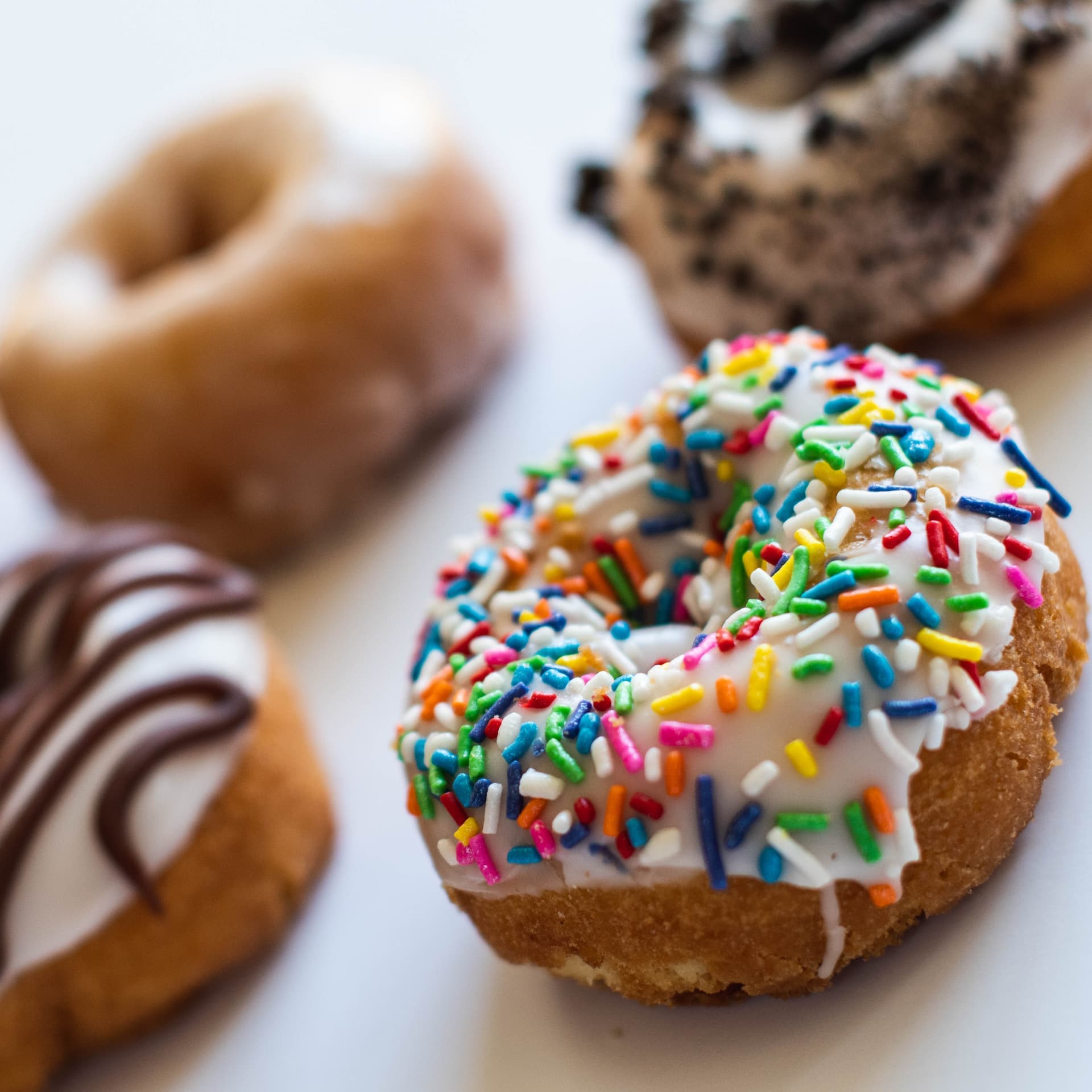 Vegan donut with rainbow sprinkles close-up