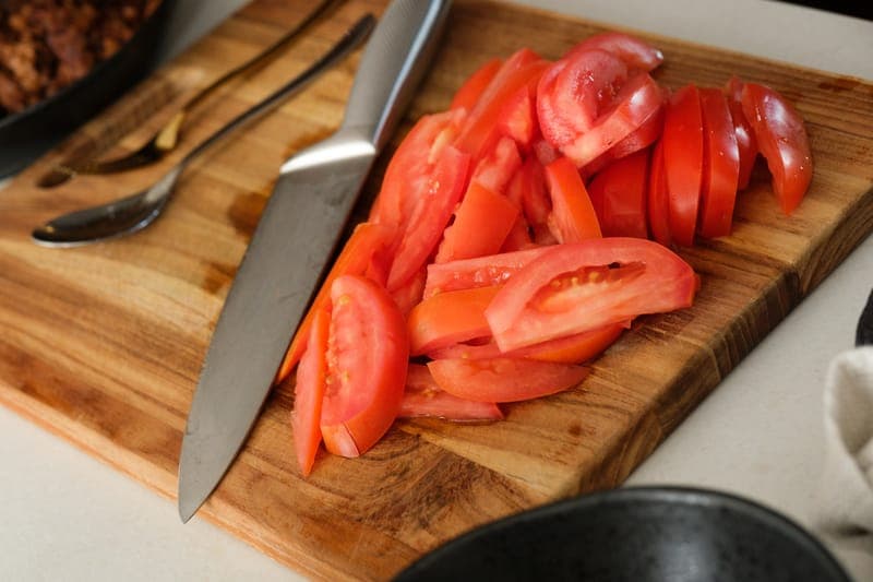 Sliced tomatoes on cutting board